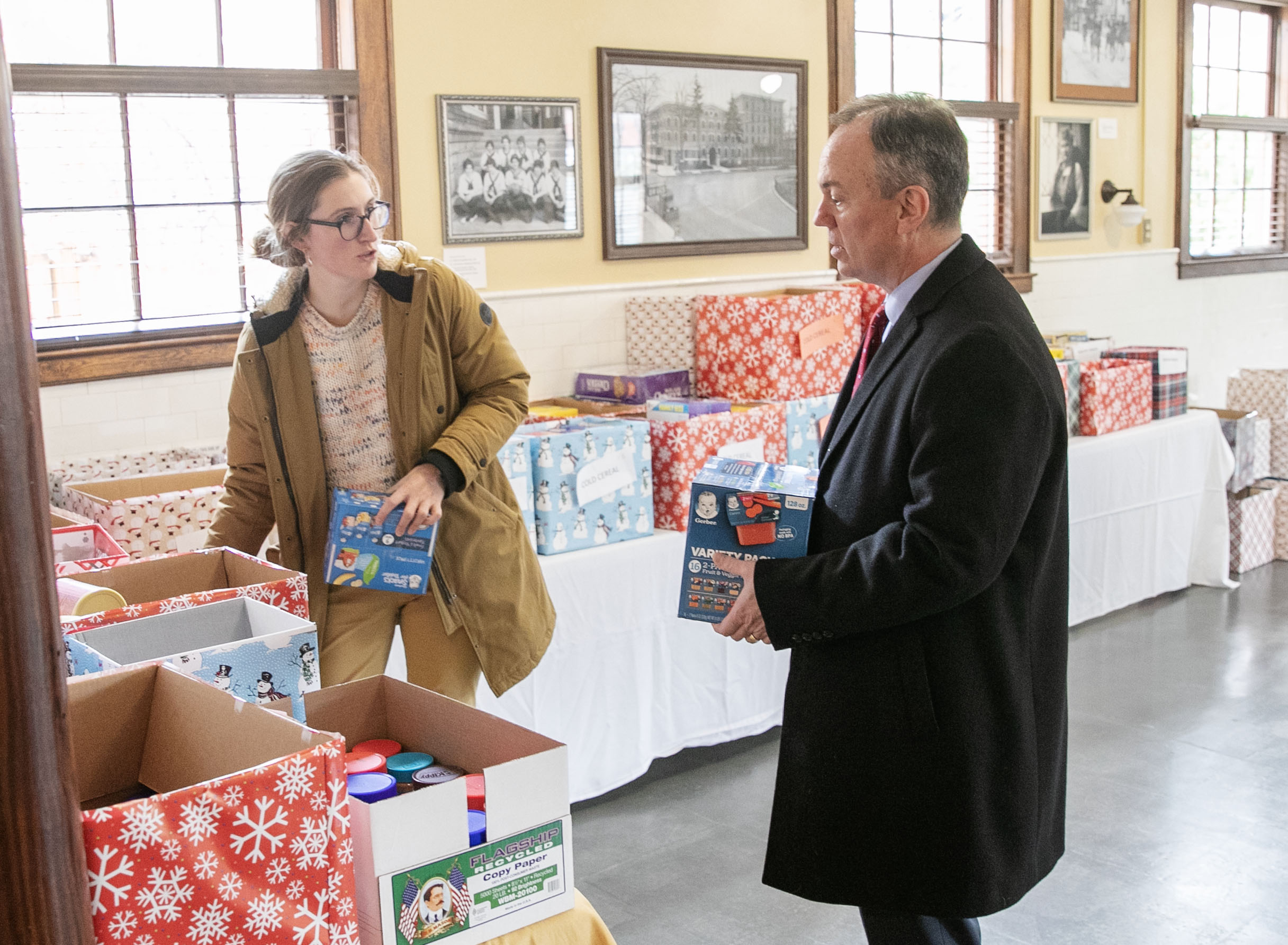 Jennifer Natyzak, assistant director of sustainability programs, and President Marc Conner process donations for Skidmore Cares.  