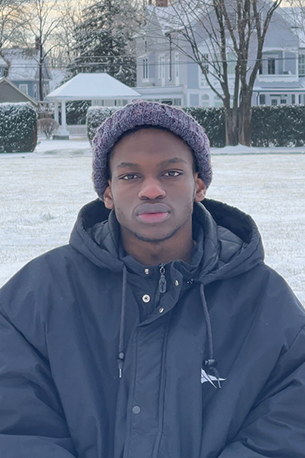 Kevin Langyintuo stands in front of a snowy field.