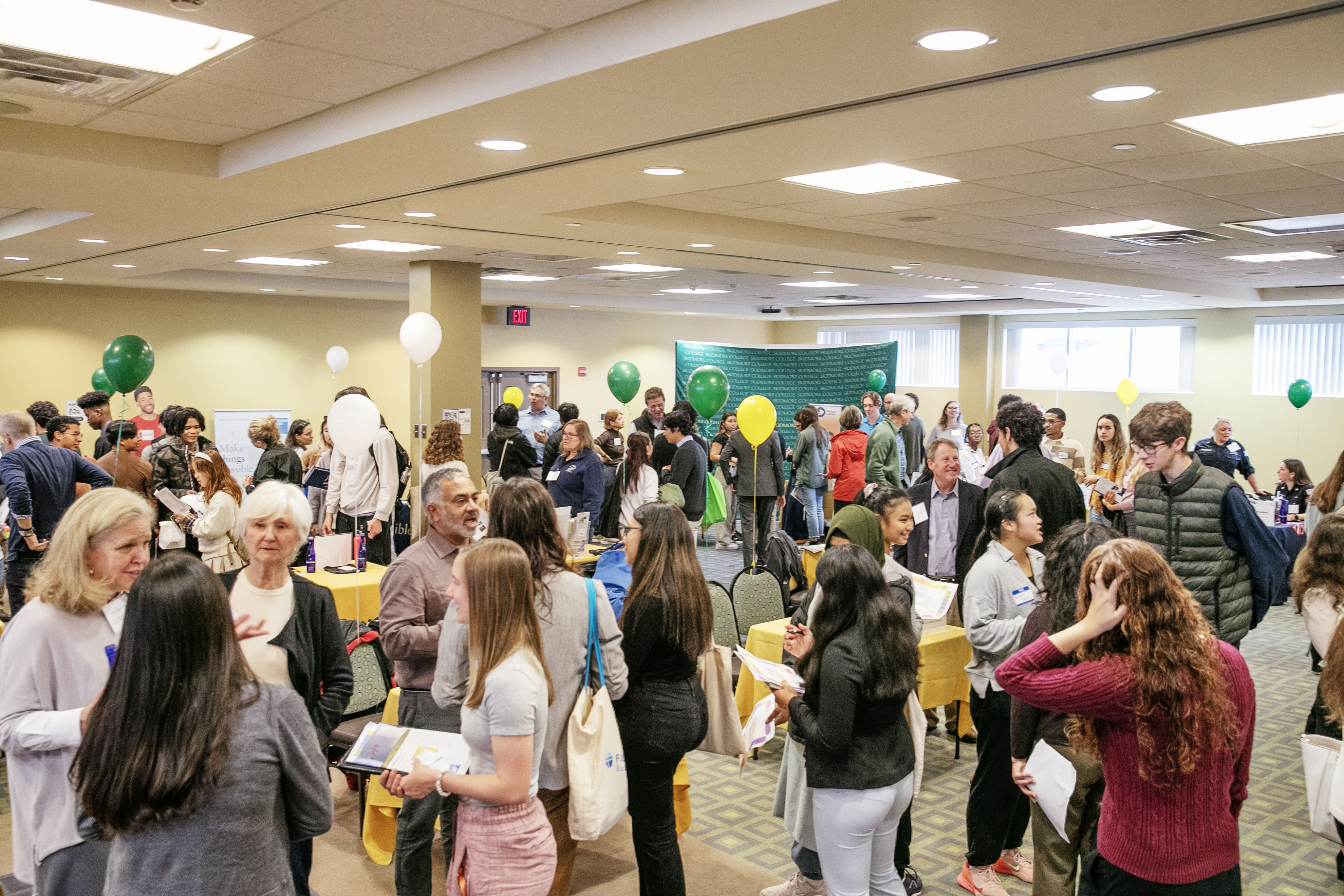 The second floor of Murray Aikins Dining Hall is full of people talking around booths.