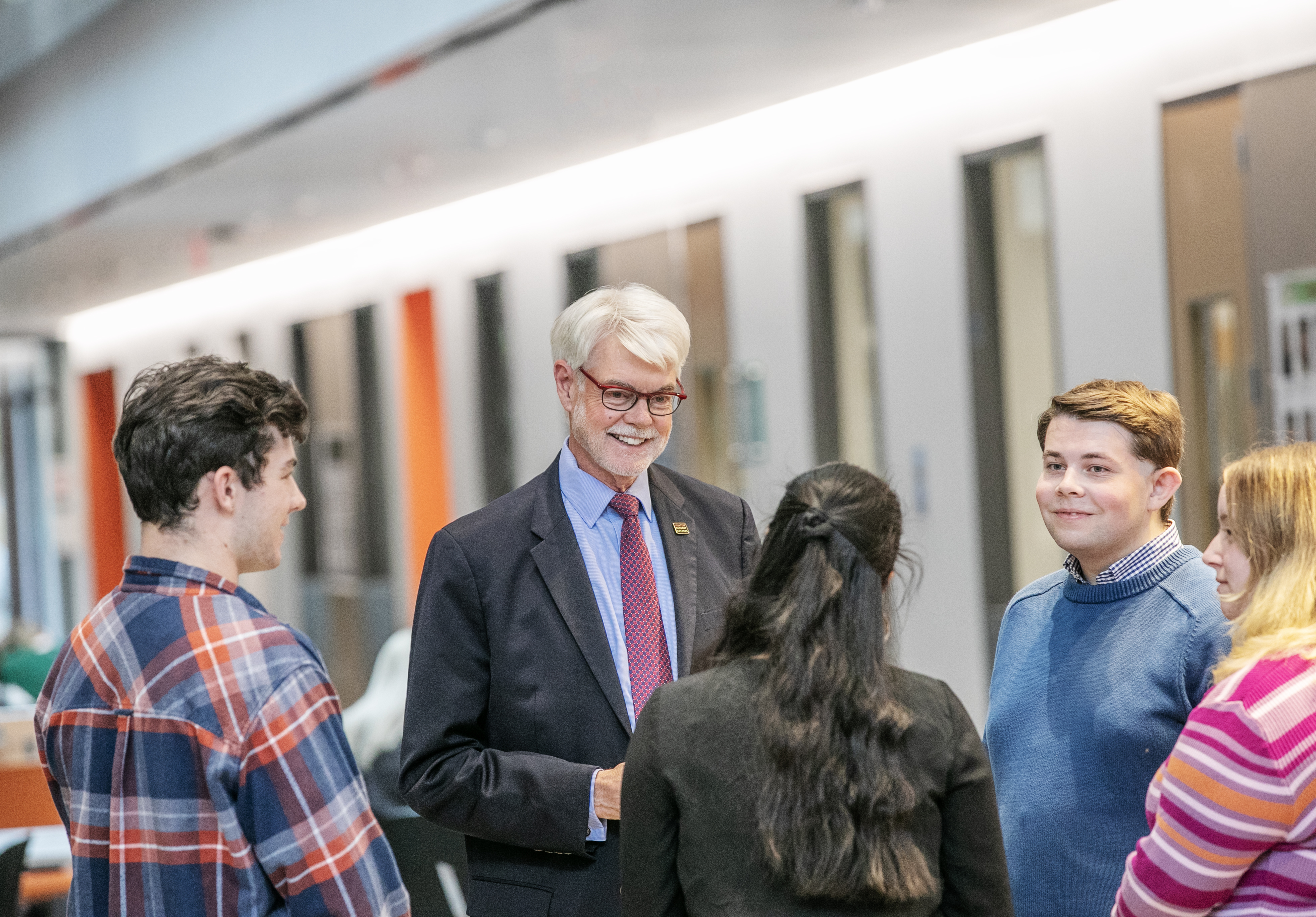 President Emeritus Philip A. Glotzbach with students in the Glotzbach Atritum of the Billie Tisch Center for Integrated Sciences. 