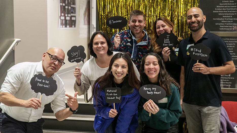Skidmore community members, including Dean of Students and Vice President for Student Affairs Adrian Bautista (left) and student organizers Apple Alvarez ’24 (first row, center) and Vicky Grijalva '24 (next to Alvarez), pose for a photo at First-Generation College Celebration Day. 