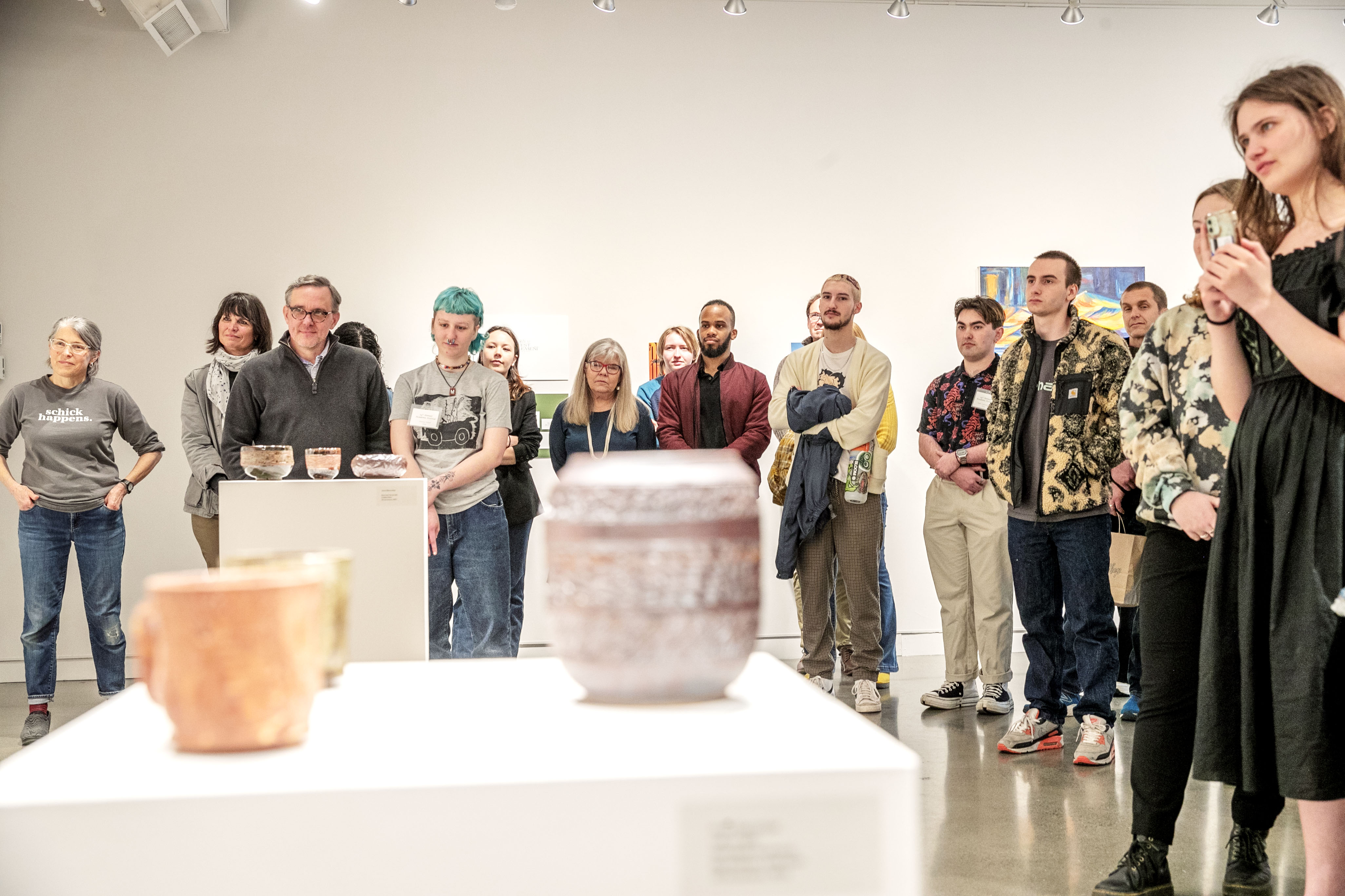 An audience listens to a student presentation in the Schick Art Gallery.