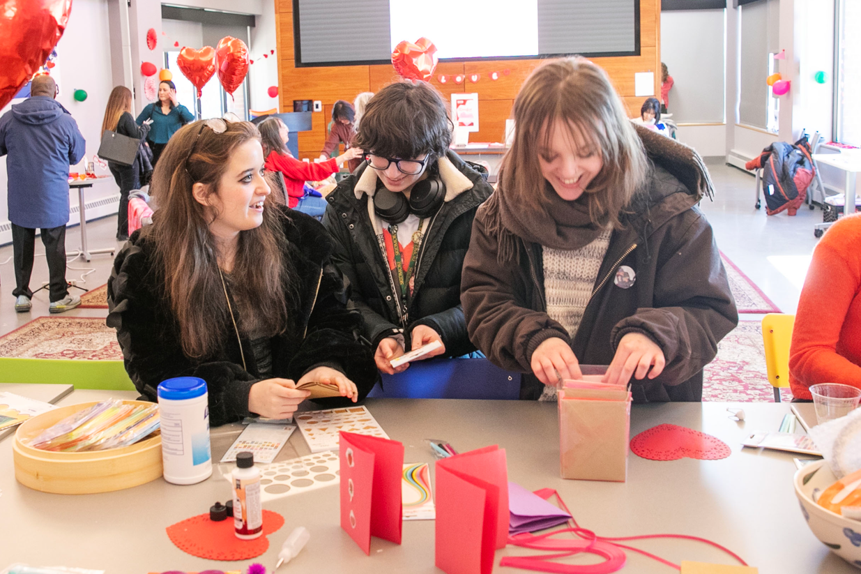Three students make valentines.