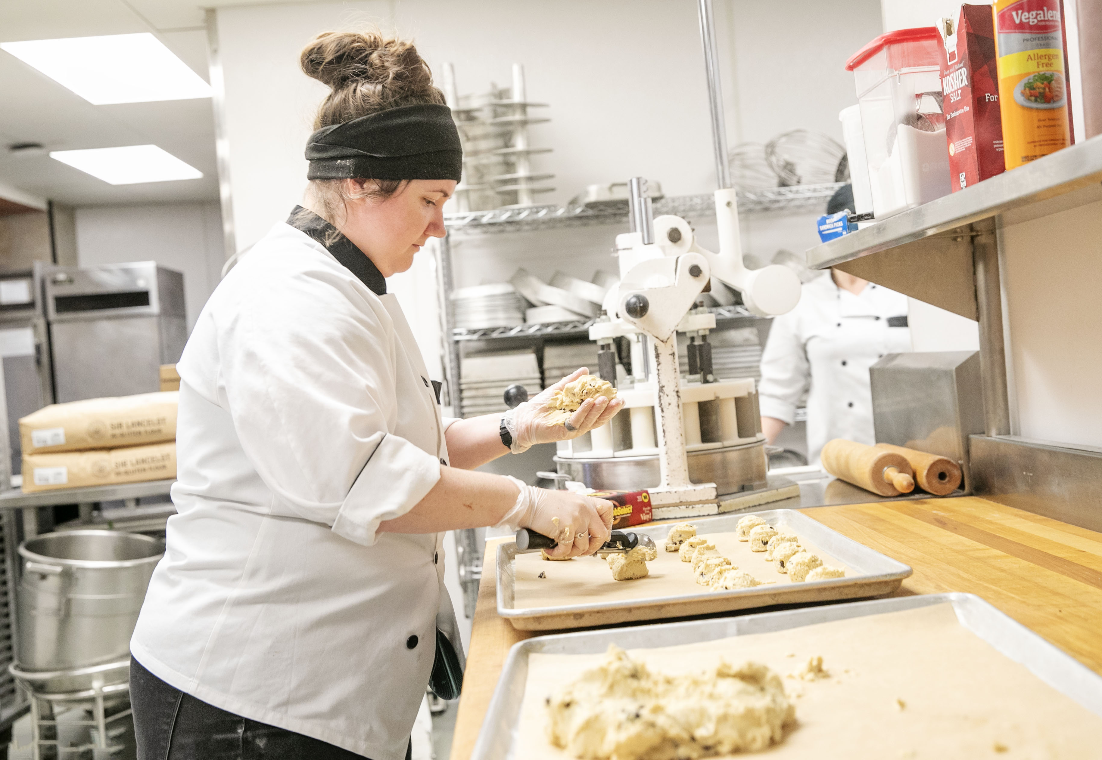 Lacey Bleau scoops cookie batter.