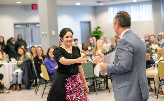 Student accepts award during 2024 Honors Convocation 
