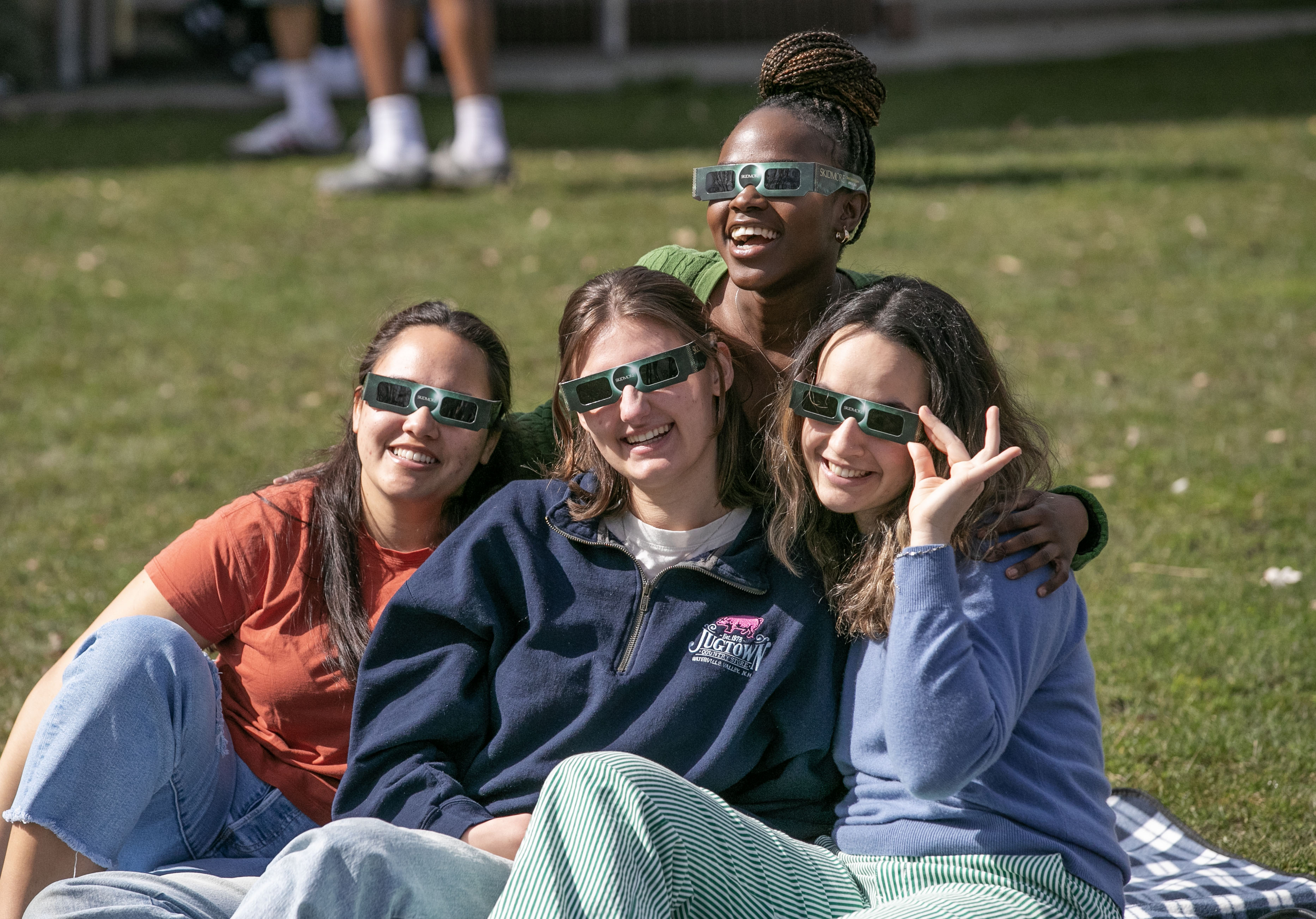 From left Micaiah Ocalvey '24, Julia Forster '24, Adriana Cuibus '24, and (back row) Anesu Mukombiwa '24 watch a near-total solar eclipse on a sunny day this spring.