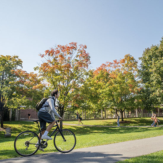 A+student+bikes+across+Skidmore%27s+campus+in+the+fall+