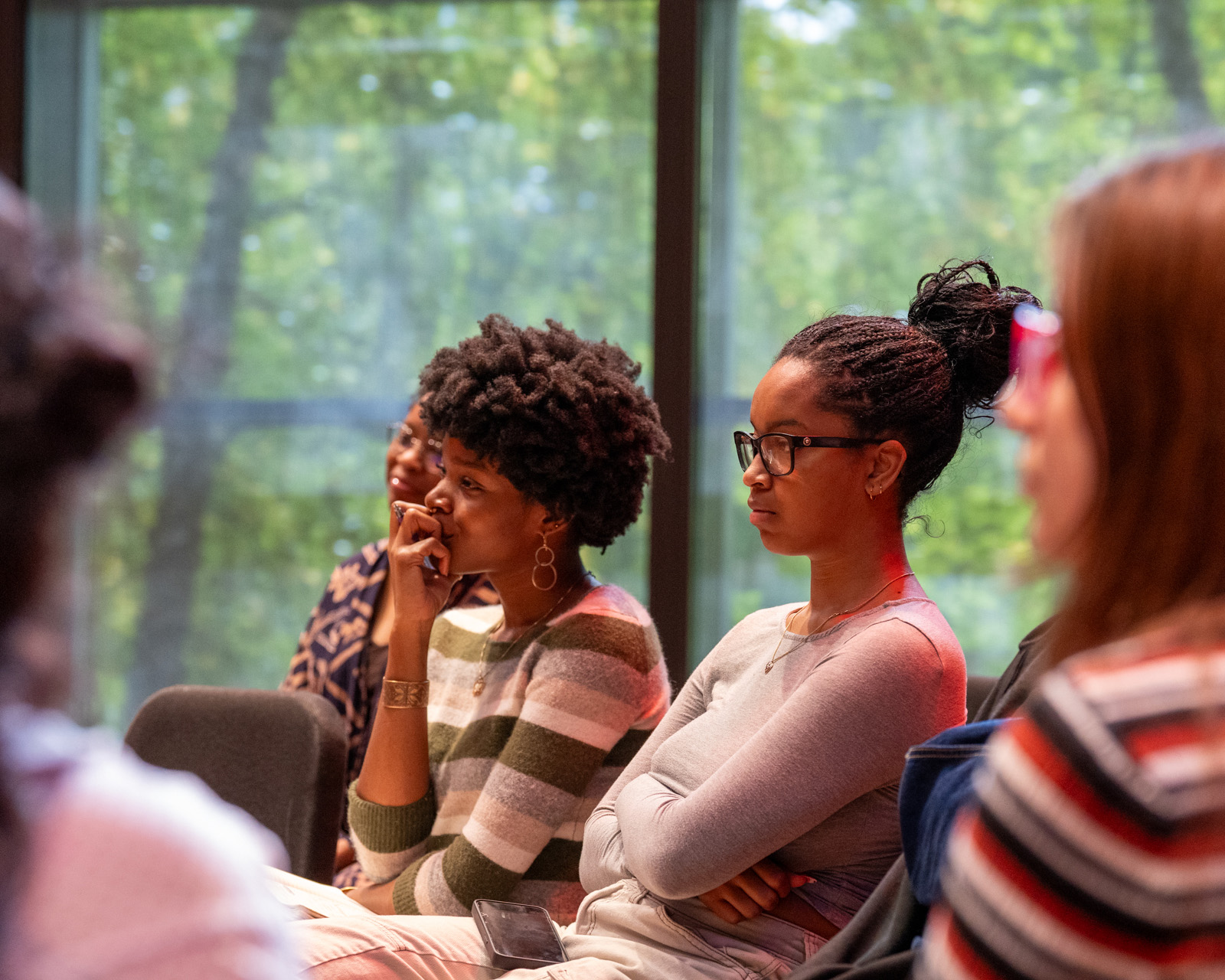 Students sit in chairs and watch during talk