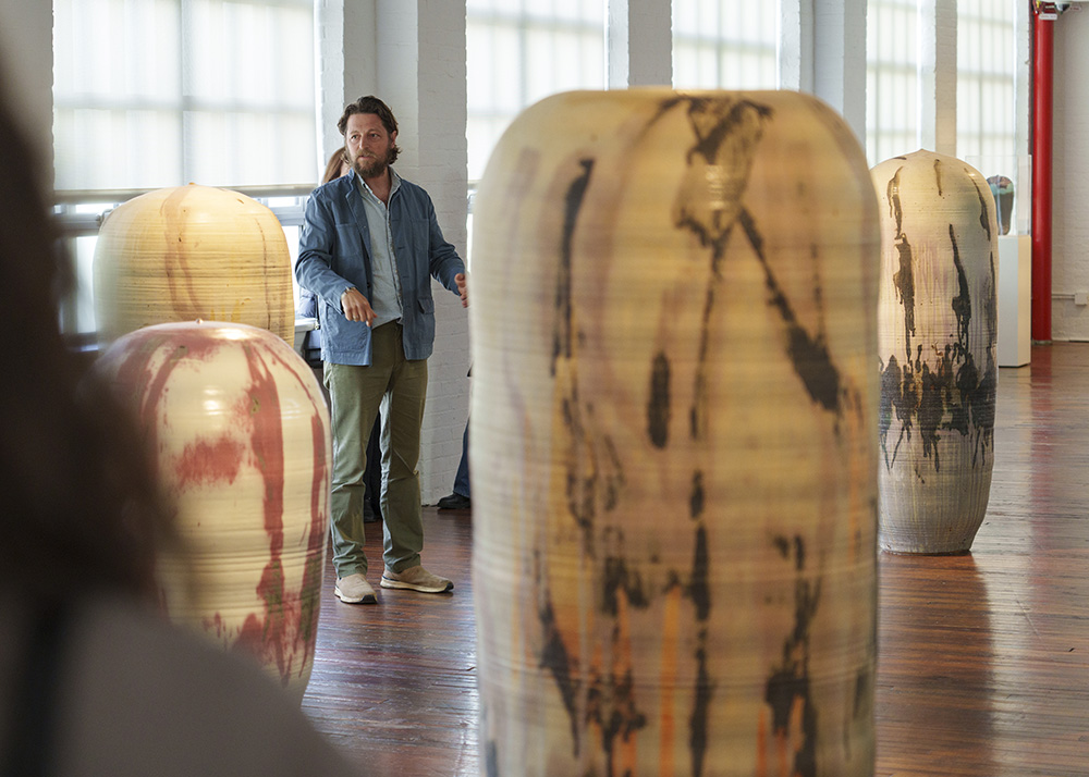 Karol standing among a number of tall, vase-like sculptures in Noguchi Museum.