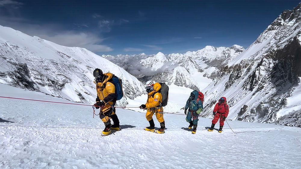 Alumnus Matt Ferrari ’05 (second from left) summited Mount Everest on May 27, carrying a Skidmore Baseball flag with him.