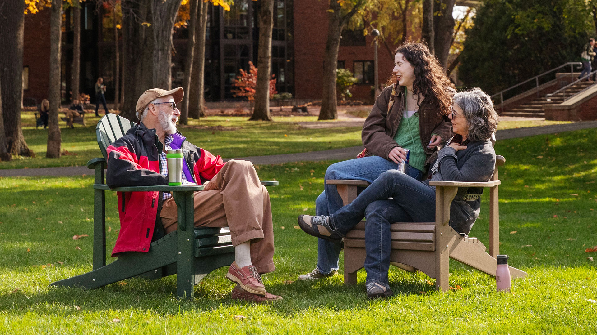 A family at Adirondack chairs on Skidmore's campus