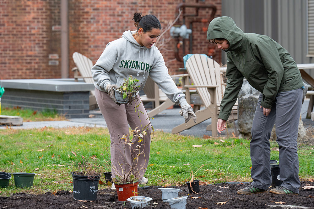 Two students planting a garden