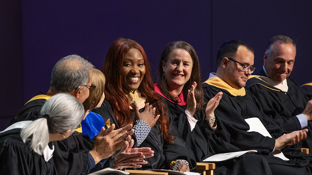 Fellow Alumni Awards recipients recognize Angela Botiba ’15 (center left, with her hand over her chest), for her enduring commitment to Skidmore during Reunion 2025. 