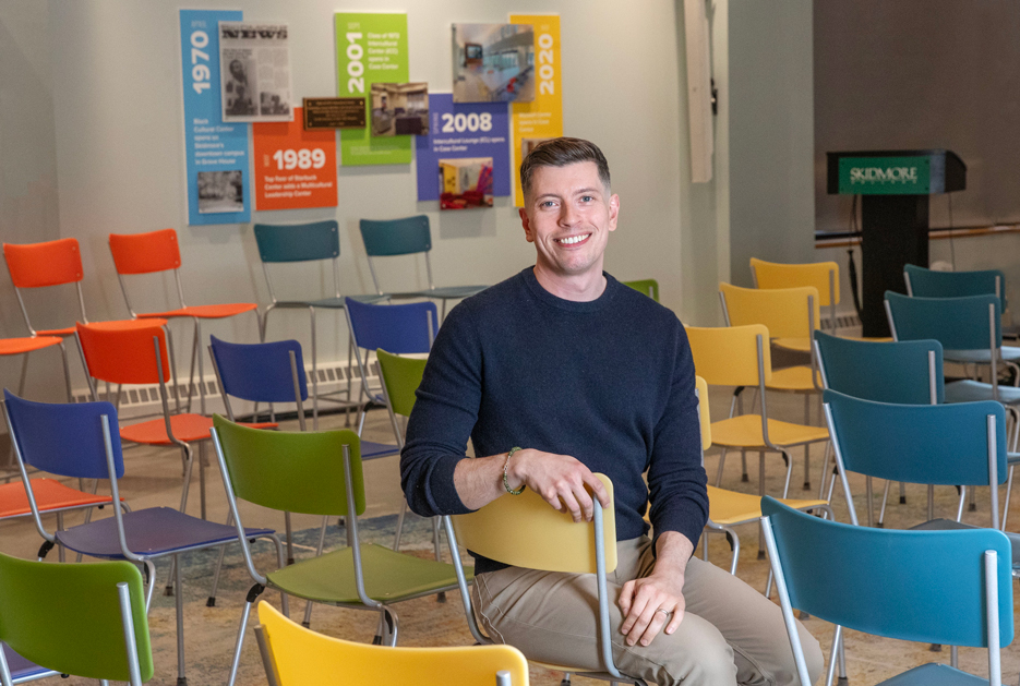 Fred Braunstein ’08 sits in a chair in Skidmore's Wyckoff Center