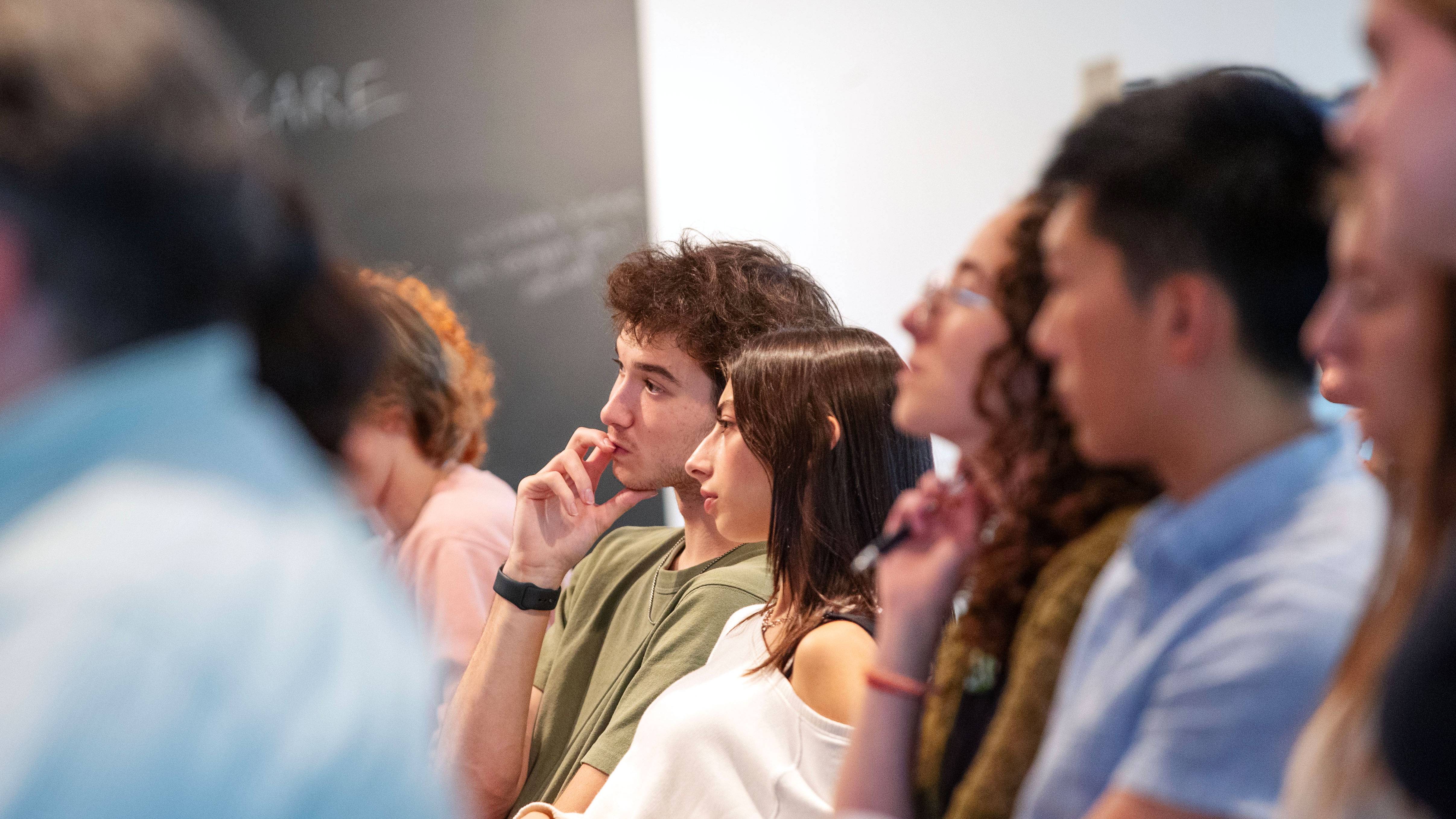Students listen intently during an election program at the Tang Teaching Museum