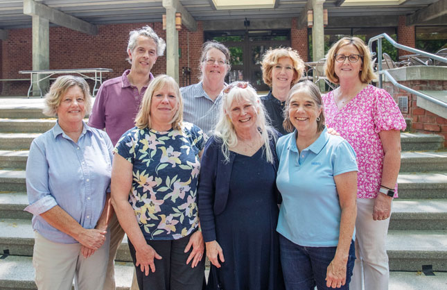 Faculty and staff celebrating their retirements gather for a group photo on the steps of Case Center.