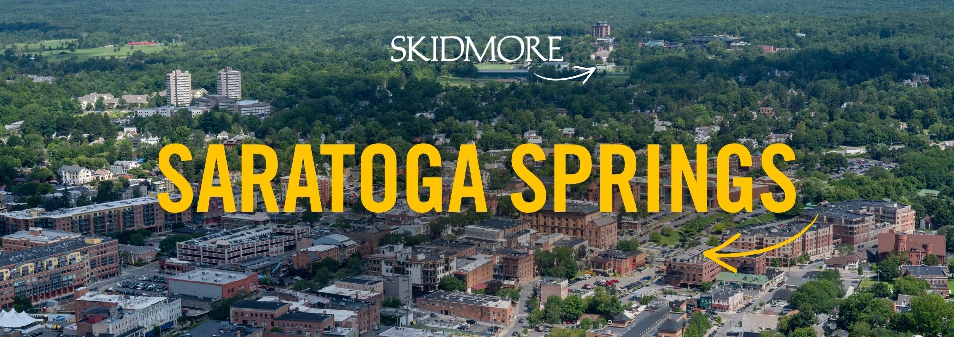 Aerial view of downtown Saratoga Springs with large text reading “Saratoga Springs” and an arrow pointing toward Skidmore College.