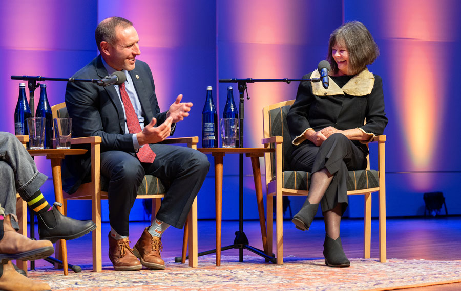 Jarod Koopman and Geraldine Brooks smile while answering questions on the stage of Zankel Music Center.