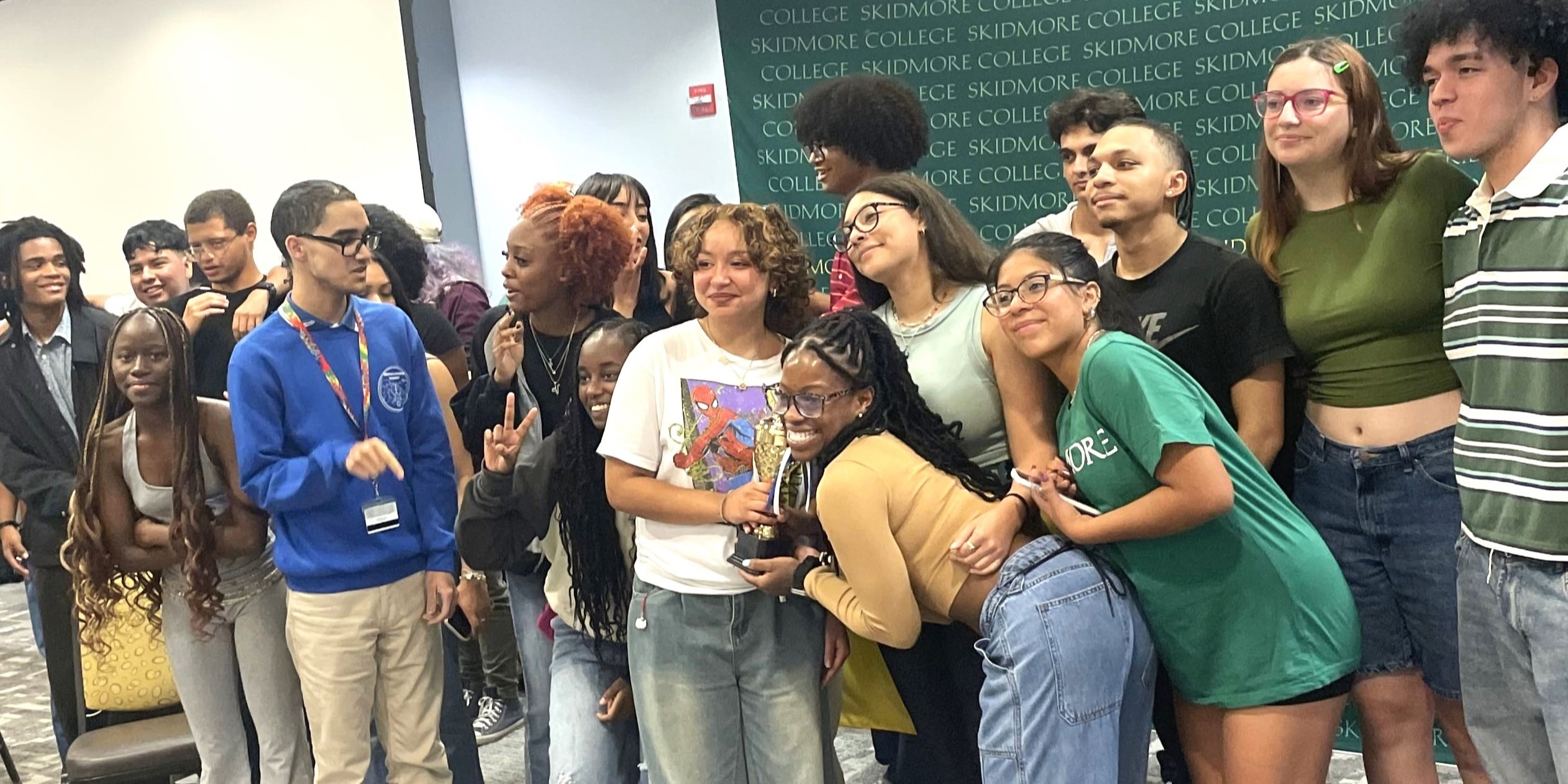 A large group of students posing in a classroom