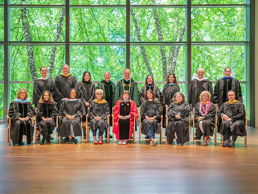 Skidmore College alumni award recipients pose in academic regalia for a group photo during Reunion.
