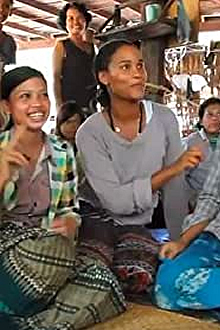 three women sitting on the ground