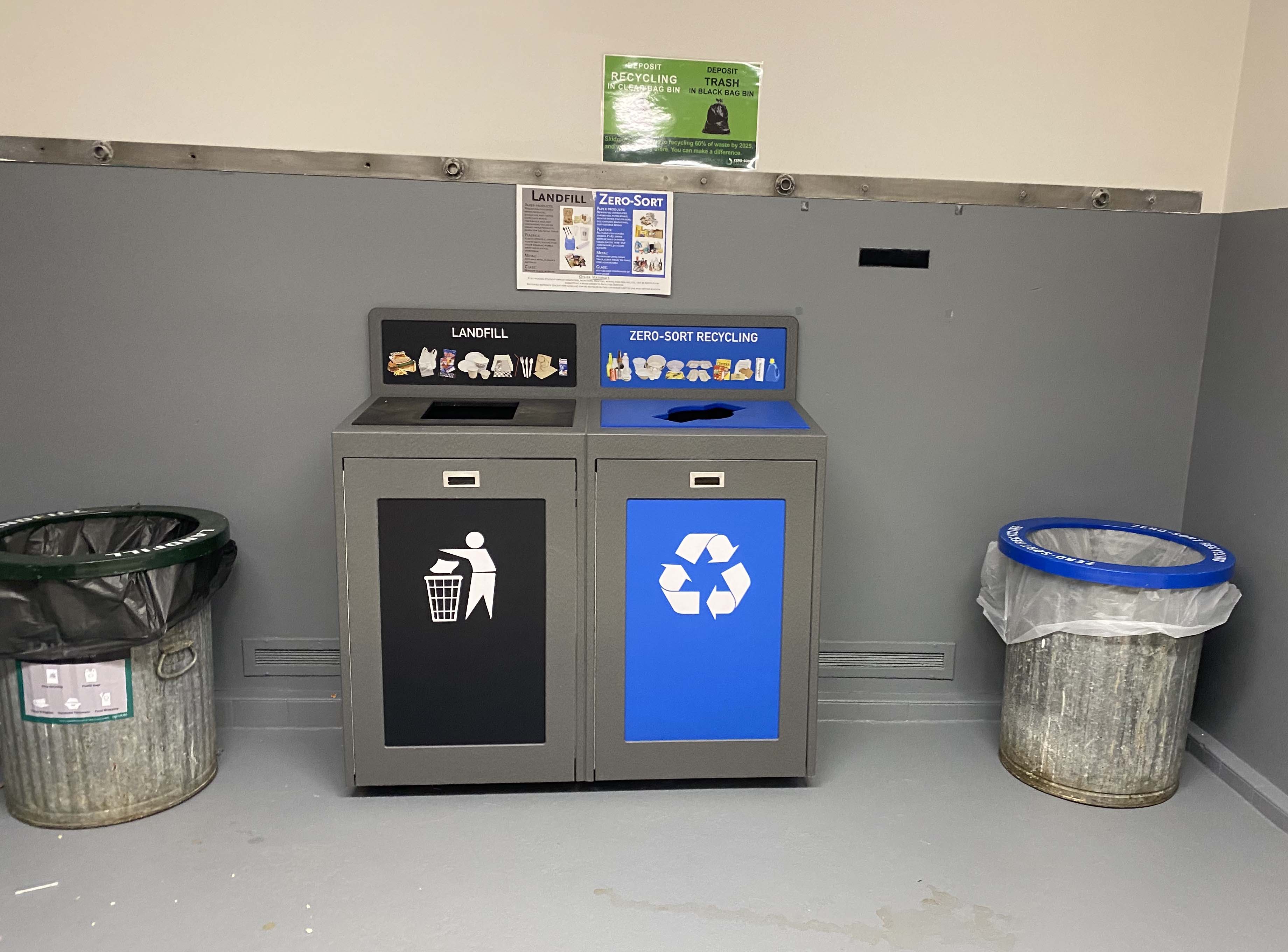 One combined unit for landfill and recycling in the middle, a recycling bin on the left and another landfill bin on the right.