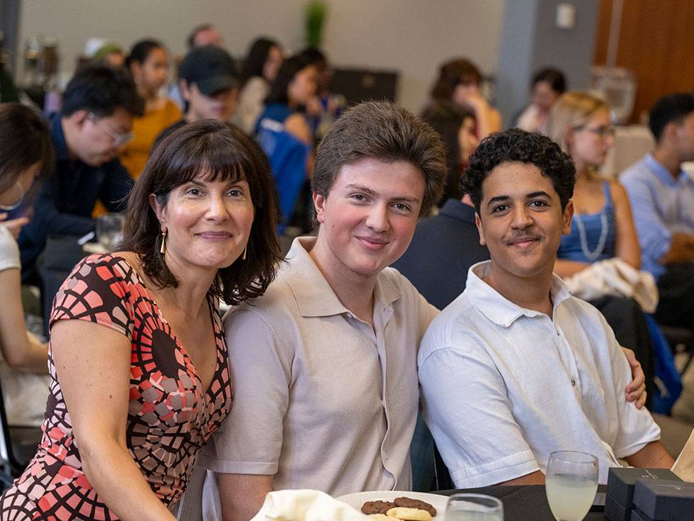 Two international students pose with Chloe Jaleel at the Davis UWC Scholars luncheon celebration