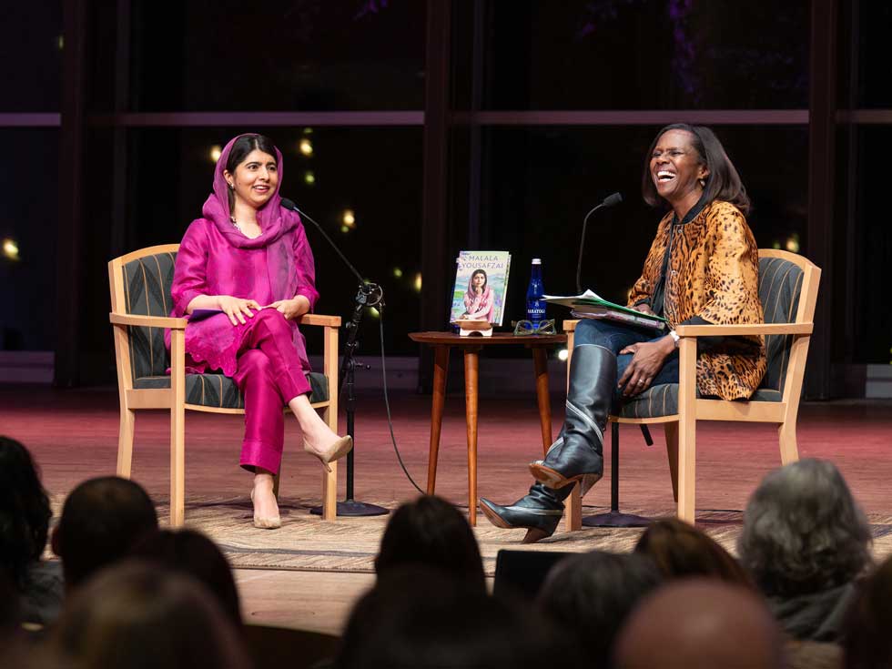Two speakers, Malala Yousafzai and Deborah Roberts, sit onstage in conversation before an audience at Zankel Music Center.