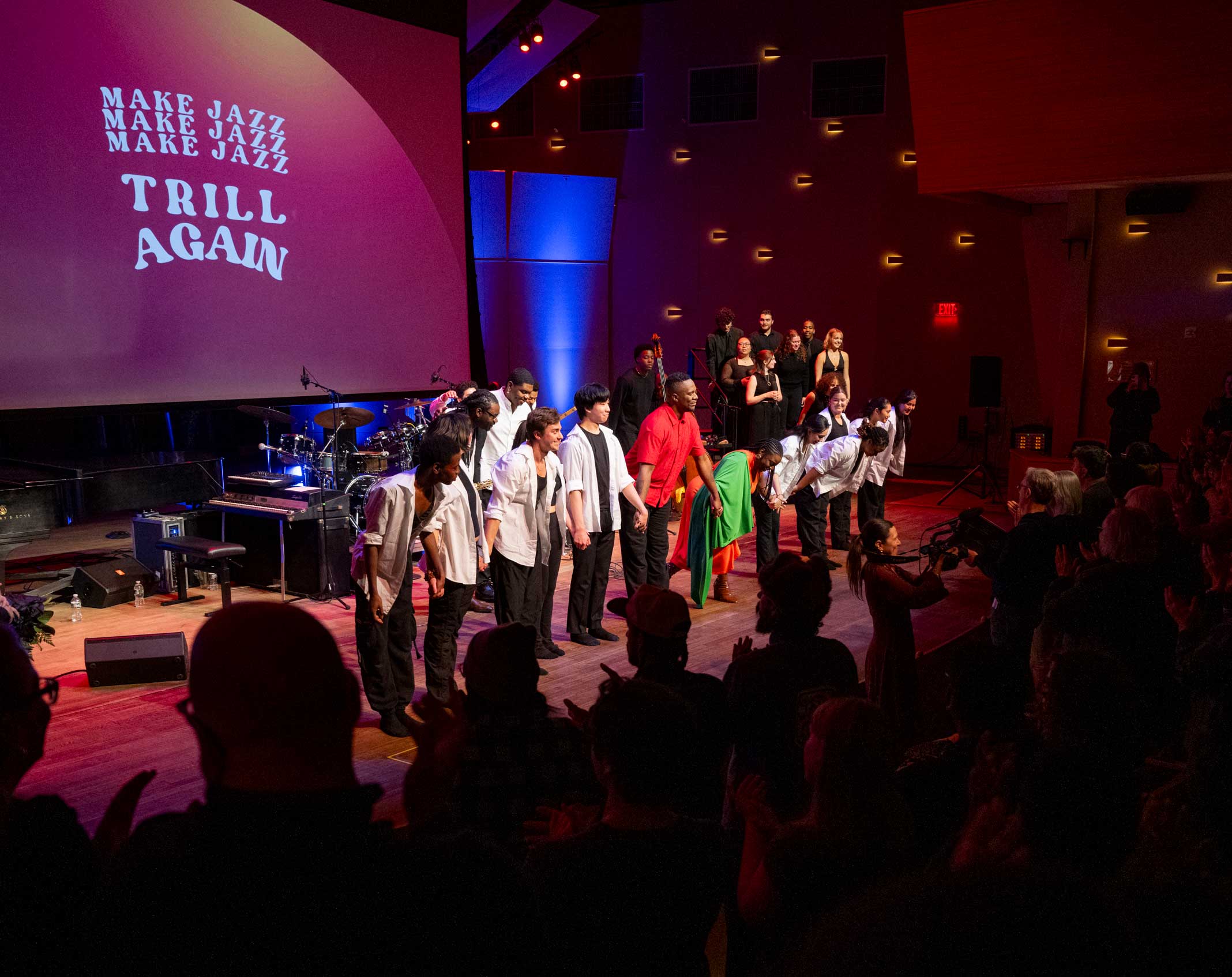 Performers bow onstage in Zankel Music Center after a “Trill Again” performance as the audience applauds.